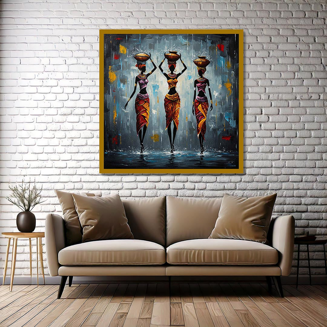 Beige sofa with decorative pillows in a room with a framed painting of three women on a white brick wall.